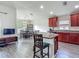 A kitchen and dining area, featuring stainless steel appliances, lots of natural light, and hardwood floors at 14371 Edinburgh Moor Dr, Wimauma, FL 33598