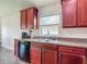 Well-equipped kitchen featuring sleek cabinetry, and stainless steel appliances at 14371 Edinburgh Moor Dr, Wimauma, FL 33598
