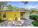 The home's backyard features a covered porch with ceiling fan and a water feature at 1510 Patricia Ave, Dunedin, FL 34698