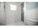 Bathroom with white subway tile shower and contrasting decorative tile, featuring built in shelf at 1510 Patricia Ave, Dunedin, FL 34698