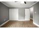 Bedroom featuring wood-look flooring, gray walls, a ceiling fan, and a closet at 1510 Patricia Ave, Dunedin, FL 34698