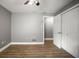 Bedroom with wood-look flooring, gray walls, a ceiling fan, and a closet at 1510 Patricia Ave, Dunedin, FL 34698