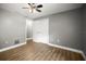 Spacious bedroom with wood-look flooring, gray walls, a ceiling fan, and a closet at 1510 Patricia Ave, Dunedin, FL 34698