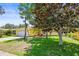 The charming yellow home features a well-maintained front yard and a large tree for shade at 1510 Patricia Ave, Dunedin, FL 34698