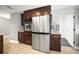 Well-equipped kitchen featuring stainless steel appliances, wood cabinets, and tiled backsplash at 1510 Patricia Ave, Dunedin, FL 34698