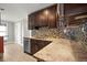 The kitchen showcases granite countertops, a stainless steel dishwasher, and chic backsplash tiles at 1510 Patricia Ave, Dunedin, FL 34698