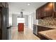 Well-lit kitchen features stainless steel appliances, stone countertops, a center island, and hardwood flooring at 1510 Patricia Ave, Dunedin, FL 34698