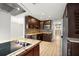Modern kitchen featuring wood cabinets, stainless steel appliances, granite counters, and a stylish backsplash at 1510 Patricia Ave, Dunedin, FL 34698