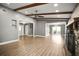 Bright living room featuring beautiful wood beams, stone fireplace, and seamless flow to other living spaces at 1510 Patricia Ave, Dunedin, FL 34698