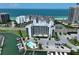 Aerial view of a condo complex with a pool, docks, and beach access at 1591 Gulf Blvd # 304S, Clearwater Beach, FL 33767