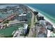 Scenic aerial view of waterfront condos, boat docks, and pristine sandy beaches along the coast at 1591 Gulf Blvd # 304S, Clearwater Beach, FL 33767