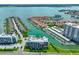 Aerial view of waterfront condos and boat docks with lush landscaping and serene water views at 1591 Gulf Blvd # 304S, Clearwater Beach, FL 33767