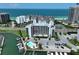 Aerial shot of a beachfront condo building with a pool, docks, and beautiful ocean views at 1591 Gulf Blvd # 304S, Clearwater Beach, FL 33767