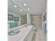 Modern bathroom with a large mirror, marble countertop, and a glass-enclosed shower at 1591 Gulf Blvd # 304S, Clearwater Beach, FL 33767