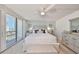 Well-lit bedroom with slider to balcony access and coastal decor at 1591 Gulf Blvd # 304S, Clearwater Beach, FL 33767