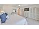 Bright bedroom with coastal decor featuring storage closets and ample closet space at 1591 Gulf Blvd # 304S, Clearwater Beach, FL 33767