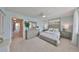 Bright bedroom features a comfortable bed and dresser with decor and carpeted flooring at 1591 Gulf Blvd # 304S, Clearwater Beach, FL 33767