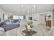 Open-concept living room with a mix of modern and comfortable furniture at 1591 Gulf Blvd # 304S, Clearwater Beach, FL 33767