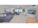 Relax in this cozy living room, featuring a plush sectional sofa and balcony access with bright natural light at 1591 Gulf Blvd # 304S, Clearwater Beach, FL 33767