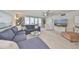 Relax in this cozy living room, featuring a plush sectional sofa and balcony access with bright natural light at 1591 Gulf Blvd # 304S, Clearwater Beach, FL 33767
