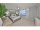 Bright bedroom with neutral decor, ceiling fan, plush carpeting, and a large window with water views at 1591 Gulf Blvd # 304S, Clearwater Beach, FL 33767