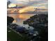 Panoramic view of the tranquil bay at sunset, surrounded by lush trees and private boat docks at 1591 Gulf Blvd # 304S, Clearwater Beach, FL 33767