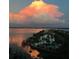 Expansive view of tranquil bay, condo buildings, and swimming pool at sunset at 1591 Gulf Blvd # 304S, Clearwater Beach, FL 33767