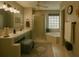 Serene bathroom featuring a double vanity, glass-enclosed shower, and soaking tub at 1607 Alexander Crossing Way, Sun City Center, FL 33573
