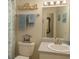 Bright bathroom featuring a granite countertop vanity, white fixtures, and decorative blue accents at 1607 Alexander Crossing Way, Sun City Center, FL 33573