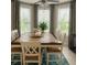 Elegant dining room featuring a large table, stylish chairs, and ample natural light at 1607 Alexander Crossing Way, Sun City Center, FL 33573