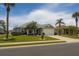Charming single-story home with a well-manicured lawn, mature trees, and a two-car garage at 1607 Alexander Crossing Way, Sun City Center, FL 33573