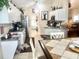 Bright kitchen boasts white cabinets, modern appliances, and a cozy breakfast nook at 1607 Alexander Crossing Way, Sun City Center, FL 33573