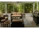 Relaxing sun room with comfortable seating, a grill, and views of lush greenery at 1607 Alexander Crossing Way, Sun City Center, FL 33573