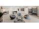 Spacious game room with comfortable seating, a foosball table, shelving, and stylish decorations at 16427 Sapphire Point Dr, Lakewood Ranch, FL 34211