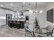 Bright kitchen with stainless steel appliances, a central island with bar seating, and an adjacent dining area at 16427 Sapphire Point Dr, Lakewood Ranch, FL 34211