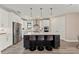 Modern kitchen featuring stainless steel appliances, a large island, and stylish pendant lighting at 16427 Sapphire Point Dr, Lakewood Ranch, FL 34211
