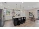 Modern kitchen featuring stainless steel appliances, a large island, and stylish pendant lighting at 16427 Sapphire Point Dr, Lakewood Ranch, FL 34211