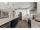Bright kitchen featuring stainless steel appliances, a large island, and stylish pendant lighting at 16427 Sapphire Point Dr, Lakewood Ranch, FL 34211