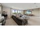 Bright living room with a large gray sectional sofa and movie decor at 16427 Sapphire Point Dr, Lakewood Ranch, FL 34211