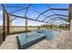 A screened-in pool and spa with a serene lake view, surrounded by lush landscaping at 16427 Sapphire Point Dr, Lakewood Ranch, FL 34211
