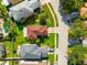 Aerial view of a single-Gathering home with a well-manicured lawn, mature trees, and a neighborhood street at 17509 Queensland St, Land O Lakes, FL 34638