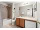 Bathroom with a shower-tub combo, tile surround, and vanity with plenty of counter space at 17509 Queensland St, Land O Lakes, FL 34638