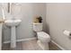 Cozy powder room with a pedestal sink, tile flooring, and neutral wall paint at 17509 Queensland St, Land O Lakes, FL 34638