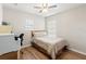 Bedroom with hardwood floors, neutral walls, and two windows at 17509 Queensland St, Land O Lakes, FL 34638