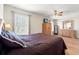 Bedroom featuring a large bed, hardwood floors, and closet space at 17509 Queensland St, Land O Lakes, FL 34638