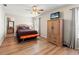 Bedroom with hardwood floors, decorative accents, and an adjacent bathroom at 17509 Queensland St, Land O Lakes, FL 34638