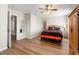 Spacious bedroom with a king-size bed and hardwood floors with natural light at 17509 Queensland St, Land O Lakes, FL 34638