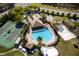 Community pool view featuring lounge chairs, splash pad, and nearby tennis and volleyball courts at 17509 Queensland St, Land O Lakes, FL 34638