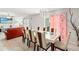 Open dining area with decorative lighting, view of the living room, and access to the backyard at 17509 Queensland St, Land O Lakes, FL 34638