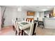 Bright dining area featuring an elegant modern table and view into the kitchen at 17509 Queensland St, Land O Lakes, FL 34638